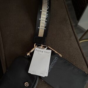 lululemon Black and gold wristlet Bags
